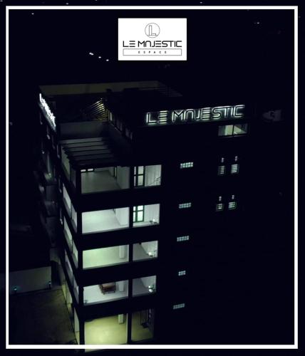 a night view of a building with a sign on it at Le Majestic Toamasina Hotel in Toamasina