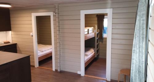 a room with two bunk beds in a house at Strandbu Camping in Skibotn