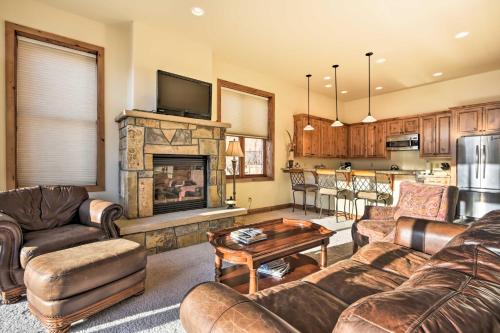 a living room with leather furniture and a fireplace at Crested Butte Townhome with Views - Steps to Lifts! in Mount Crested Butte
