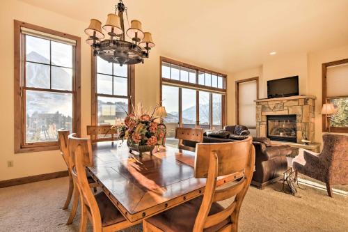 a dining room with a table and a fireplace at Crested Butte Townhome with Views - Steps to Lifts! in Mount Crested Butte