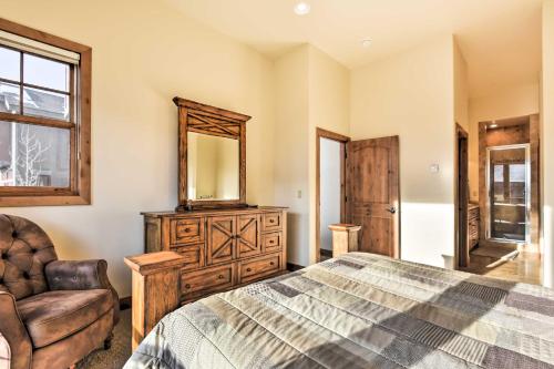a bedroom with a bed and a mirror and a chair at Crested Butte Townhome with Views - Steps to Lifts! in Mount Crested Butte