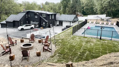 an aerial view of a house with a swimming pool at Hideaway Lodge - Glen Lake, Lake George in Lake George