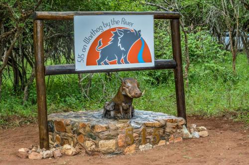 a sign with a statue of a horse on a rock at 515 on Warthog by the River in Marloth Park