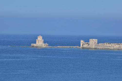 two castles on an island in the water at Villa Valleyview Methoni in Methoni