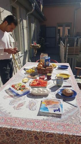 a man standing at a table with food on it at Wohnen im Dreiseitenhof mit Galerieschlafzimmer in Neudietendorf