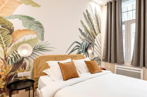 a bedroom with a bed with a tropical wallpaper at HolidaysInParis - Bonne Nouvelle in Paris