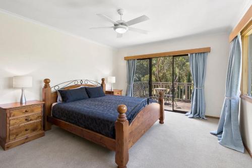 a bedroom with a bed and a large window at Creating Memories on Wyndham - sleeps 16! in Drysdale