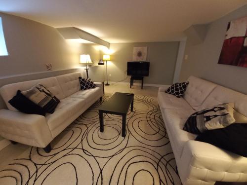 a living room with two couches and a television at Niagara Falls Dream Family Retreat in Niagara Falls