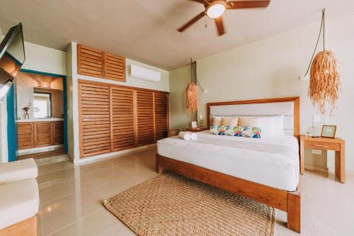 a bedroom with a large bed and a bathroom at Albatros Suites by Bedsfriends in Cozumel