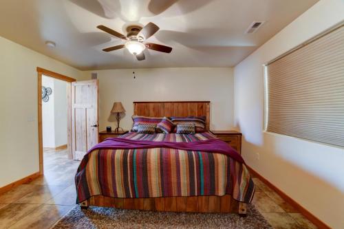 a bedroom with a bed and a ceiling fan at Steel Bender Villa in Moab