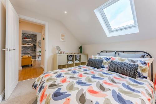 a bedroom with a large bed and a window at Fishermans Rest in Sheringham