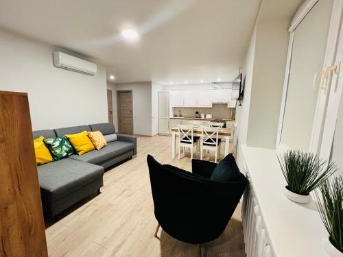 a living room with a couch and a table at Saulėti apartamentai Trakuose/Sunny apartment in Trakai in Trakai