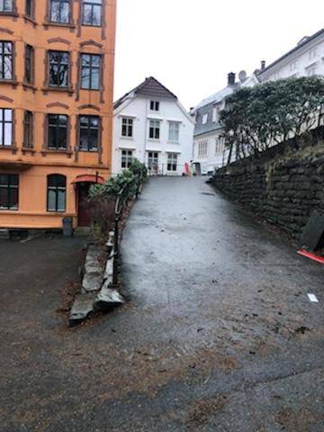 an empty street in a city with buildings at Fløyen Apartment in Bergen