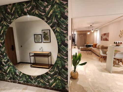 a living room and a living room with a mirror at Appartement Morillon 47 ou 39 au quartier Maarif in Casablanca