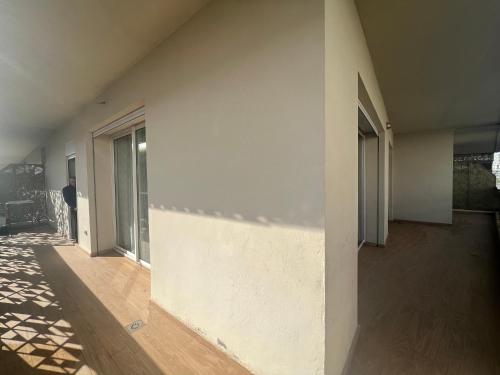 a room with a white wall and a person standing next to a building at Anfa Sky Luxury Apart by SABOR VOYAGE in Casablanca