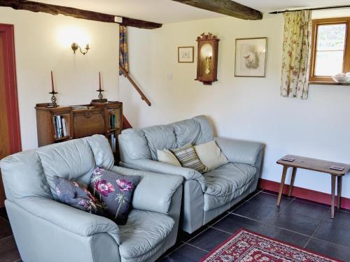 a living room with a couch and a table at Strawberie Cottage - E2390 in Stoke Abbott
