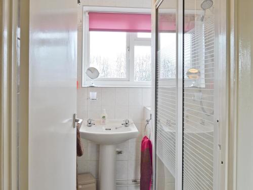 a bathroom with a sink and a window at Heath View Cottage in Westleton