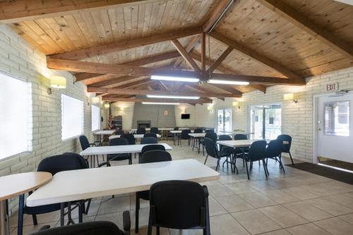 a classroom with tables and chairs in a room with wooden ceilings at Palm Springs Camping Resort Loft Cabin 1 in Palm Desert