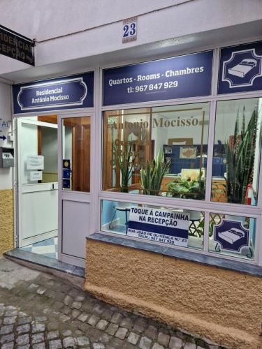 a store front of a building with a sign in the window at Residencial Antonio Mocisso Guesthouse in Elvas