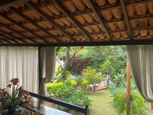 a view from the porch of a house with a garden at Pousada Canto Feliz in Serra do Cipo