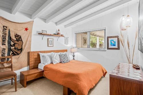 a bedroom with a bed and a chair at Casa Mesa in Santa Barbara