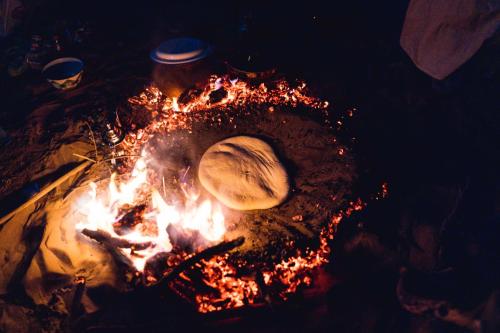 aurger sitting on top of a camp fire at hotel riad kasbah sbai palace in Mhamid