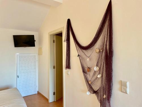 a net hanging on a wall in a bedroom at Golden Club- Eyes on Sea in Cabanas de Tavira