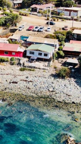 an aerial view of a town next to a body of water at Casa Caleta Vieja Pichidangui in Los Vilos