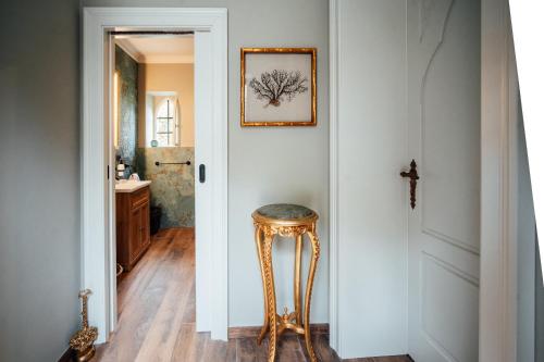 a bathroom with a stool next to a door at Hrad Kunzov Boutique Hotel & SPA & Restaurant in Radíkov