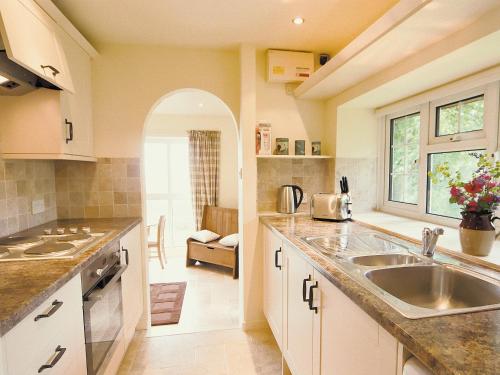 a kitchen with a sink and a counter at Spring Cottage - Hw7734 in Tintern