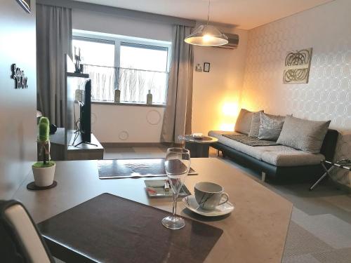 a living room with a table and a couch at Business Apartments in Hohenems