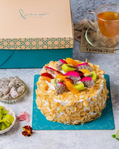 a cake with fruit on top on a table at Radisson Mumbai Goregaon in Mumbai