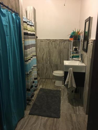 a bathroom with a sink and a toilet at MEDUSA'S HOSTEL in Aguadilla