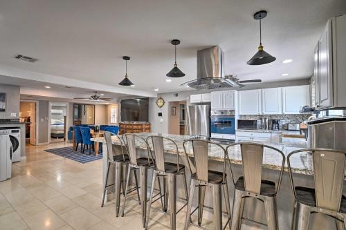 a kitchen with a bar with chairs in it at Home with Private Pool - Near Las Vegas Strip! in Las Vegas