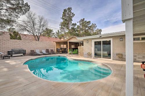a swimming pool in the backyard of a house at Home with Private Pool - Near Las Vegas Strip! in Las Vegas