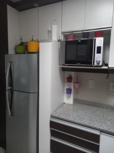 a kitchen with a refrigerator and a microwave at Mendoza is life in Guaymallen