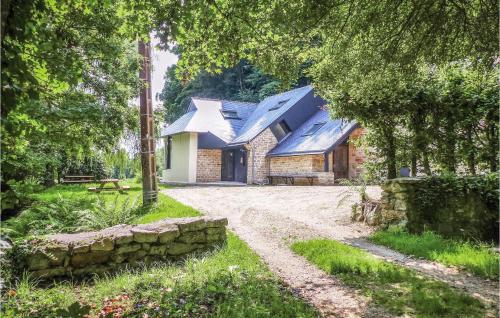 a stone house with a blue roof and a dirt road at 3 Bedroom Amazing Home In Bannalec in Bannalec