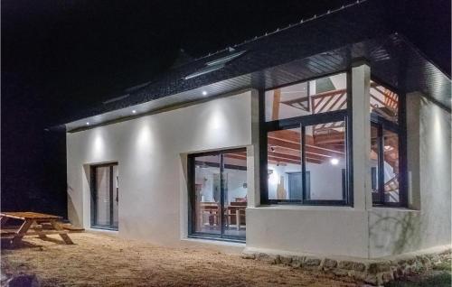a building with windows and a picnic table in front of it at 3 Bedroom Amazing Home In Bannalec in Bannalec