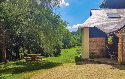 a picnic table in a field next to a house at 3 Bedroom Amazing Home In Bannalec in Bannalec