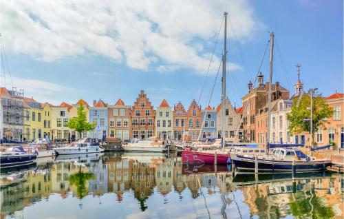 a group of boats docked in a harbor with buildings at Awesome Home In Heinkenszand With Wifi in Heinkensand