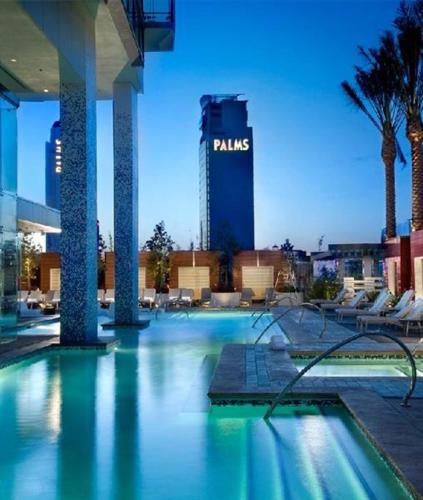 a swimming pool with a hotel in the background at Luxury 53rd Flr Condo with Amazing Sunset View & Balcony NO ReFee at Palms Place in Las Vegas