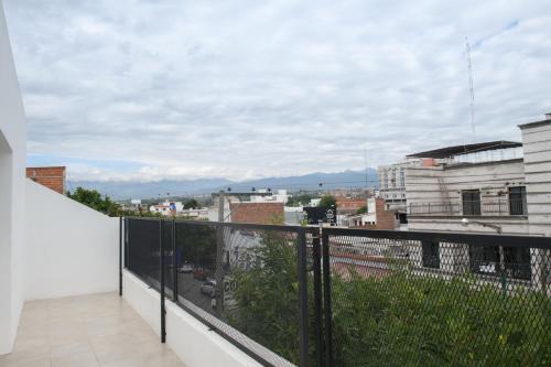 a balcony with a view of a city at Departamento con terraza y quincho con asador in Salta