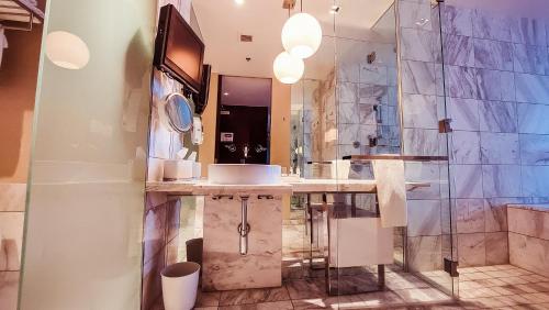 a bathroom with a sink and a shower at Luxury 53rd Flr Condo with Amazing Sunset View & Balcony NO ReFee at Palms Place in Las Vegas