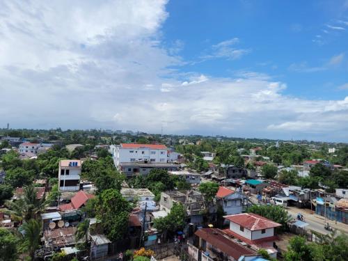 an aerial view of a city with buildings and trees at Le Majestic Toamasina Hotel in Toamasina