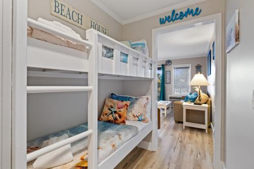 a bedroom with bunk beds and a desk at Ocean Dunes Villas Coligny Beach 43 S Forest Beach Dr, Hilton Head SC #111 Heated Pool Ocean View By Vacation Rental HHI LLC in Hilton Head Island