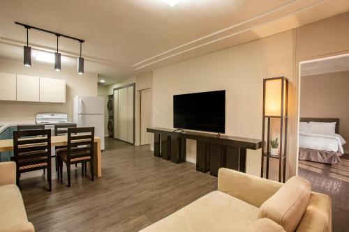 a living room with a kitchen and a dining room at The Bayview Hotel Guam in Tumon