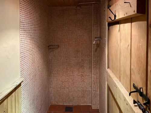 a bathroom with a shower with tiled walls at Finkle Barn in Fryup