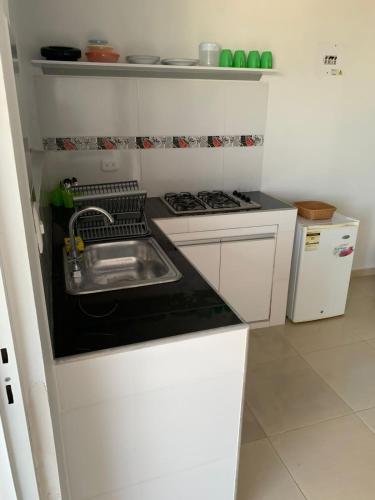 a small kitchen with a sink and a stove at Aloha Beach SAI in San Andrés