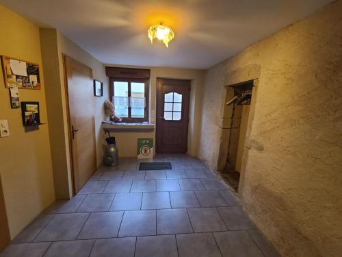 a hallway of a house with a sink and a bathroom at Gîte spacieux avec terrasse, confort moderne dans un cadre verdoyant et propice aux balades. - FR-1-589-79 in Bains-les-Bains
