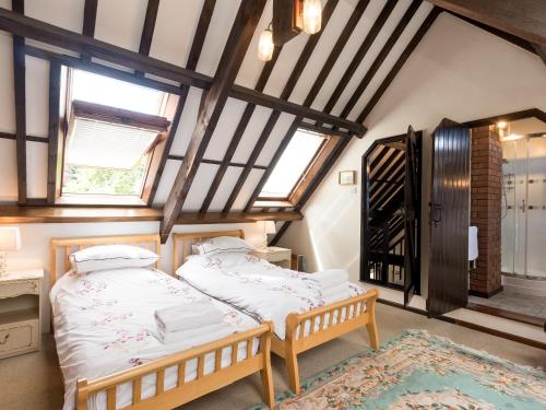 two beds in a room with two windows at Sky Lark in Weybourne